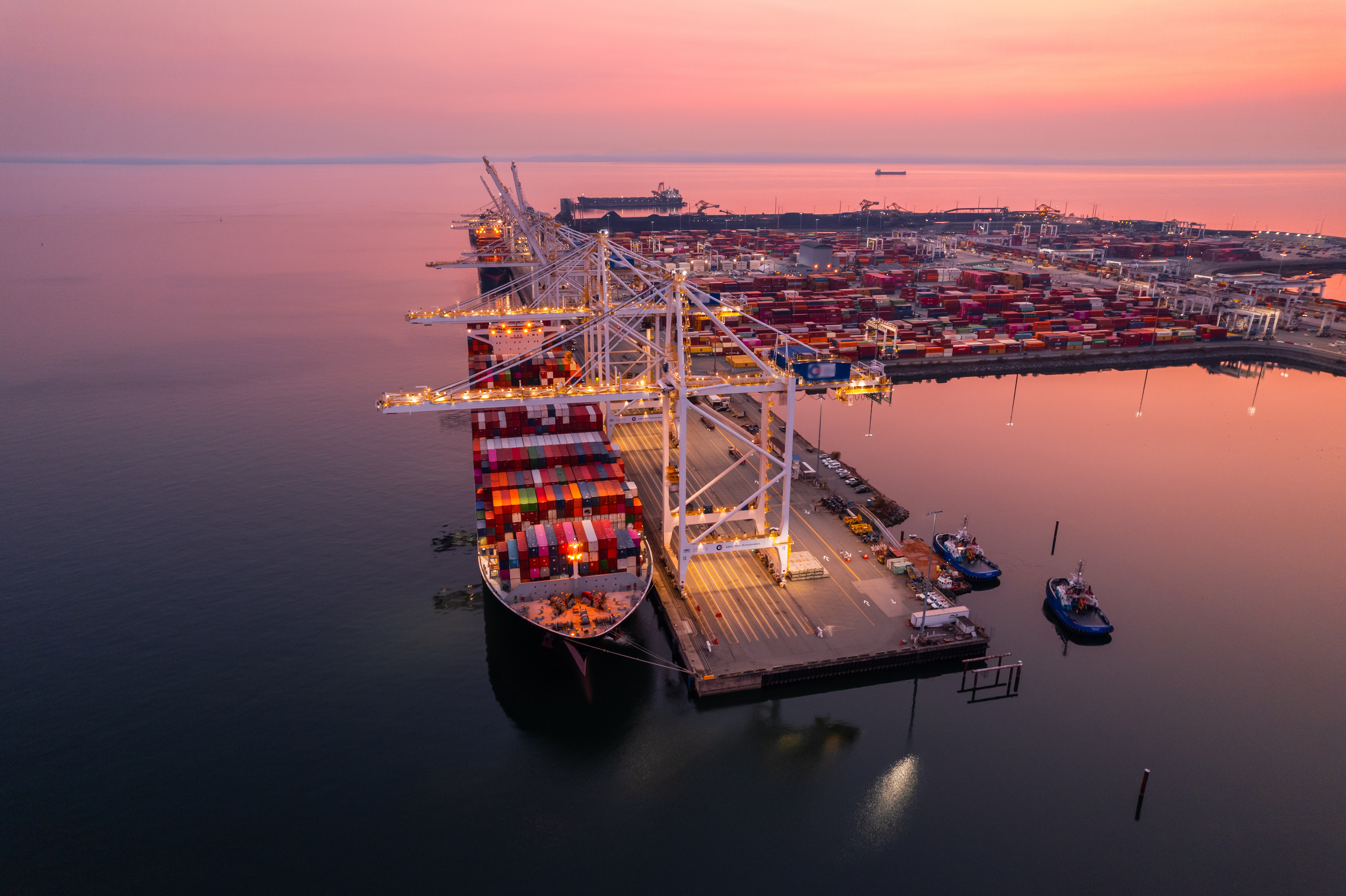 Cargo terminal loading shipping containers onto cargo ships, aerial footage, hyperlapse, Vancouver, BC, Canada, marine terminal, cargo crane